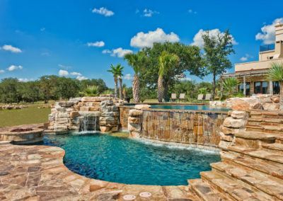 Infinity Pool Design with large catch basin with grotto and waterfall.